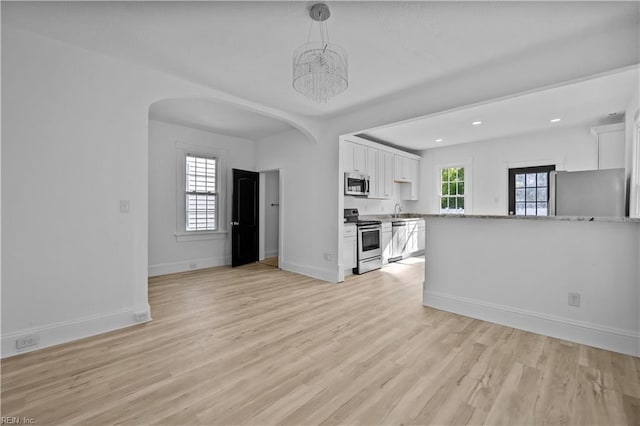 1125 Stewart St, Chesapeake, VA 23324 - unfurnished living room featuring a sink, baseboards, light wood finished floors, a notable chandelier, and recessed lighting