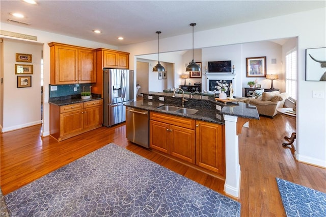 1829 Fury Way, Virginia Beach, VA 23456 - kitchen with appliances with stainless steel finishes, a center island with sink, dark wood finished floors, a sink, and open floor plan