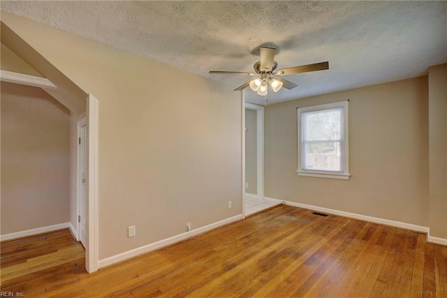 22 Mitchell Rd, Hampton, VA 23669 - spare room featuring visible vents, baseboards, ceiling fan, a textured ceiling, and light wood-style flooring