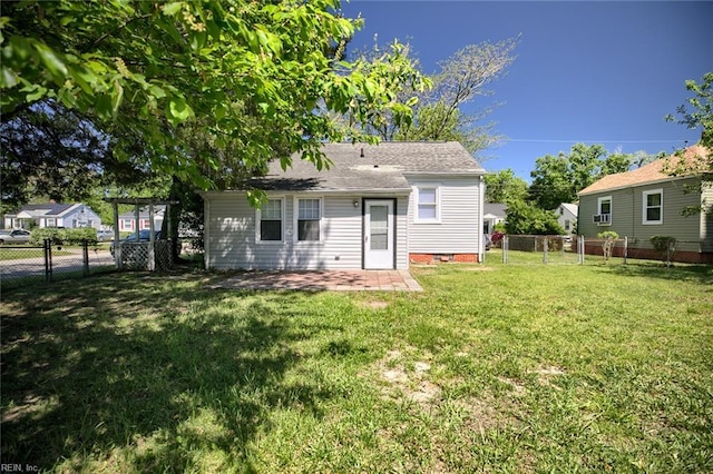 22 Mitchell Rd, Hampton, VA 23669 - rear view of house with a gate, a fenced backyard, a yard, a patio, and a shingled roof
