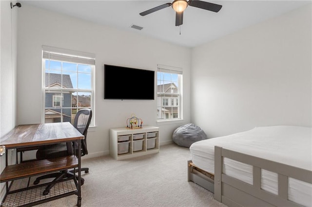 bedroom featuring multiple windows, light carpet, a ceiling fan, and visible vents