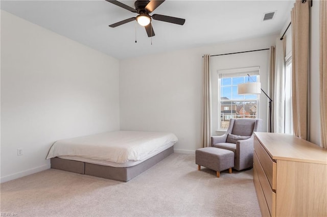 bedroom with light colored carpet, baseboards, visible vents, and a ceiling fan