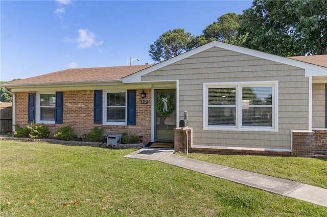 view of front of house featuring brick siding and a front lawn