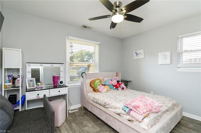 bedroom featuring dark wood finished floors, baseboards, and ceiling fan