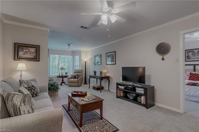 carpeted living area with ceiling fan, a textured ceiling, visible vents, crown molding, and baseboards