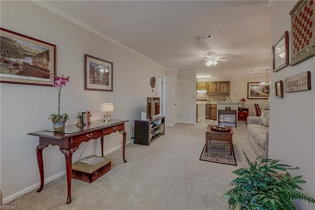 living room featuring light carpet, a ceiling fan, baseboards, visible vents, and ornamental molding