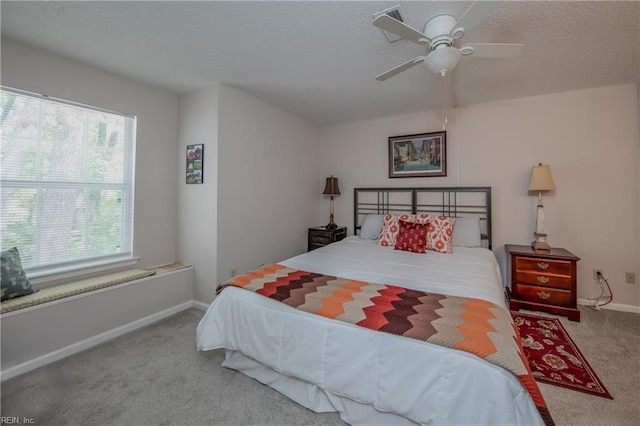 bedroom featuring carpet flooring, a ceiling fan, baseboards, and multiple windows