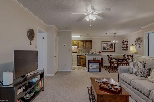 living room with a textured ceiling, light colored carpet, baseboards, ceiling fan with notable chandelier, and ornamental molding