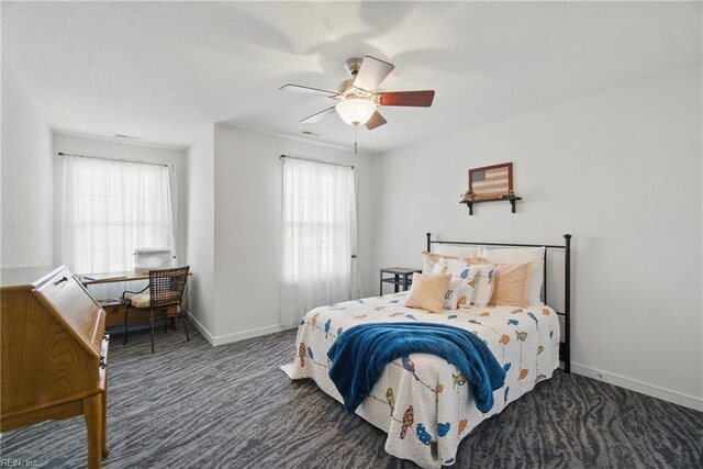 bedroom with a ceiling fan, baseboards, multiple windows, and carpet