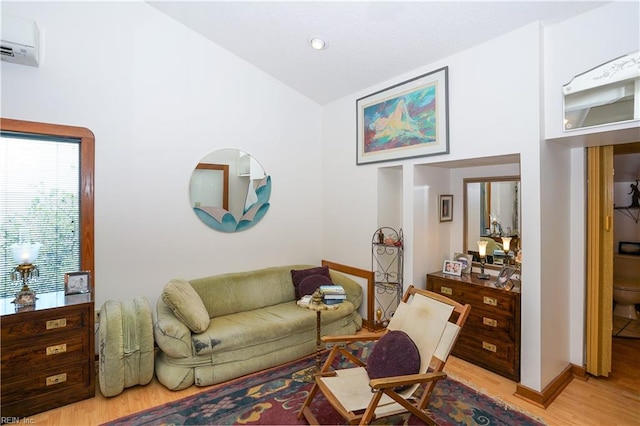 living area with light wood-style floors, recessed lighting, baseboards, vaulted ceiling, and a wall mounted AC