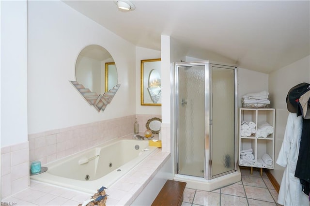 bathroom featuring a jetted tub, tile patterned floors, a stall shower, and lofted ceiling