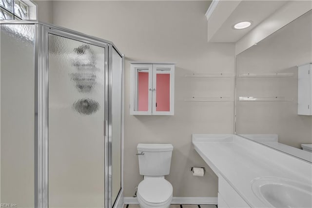 full bathroom with vanity, baseboards, a stall shower, and toilet