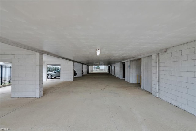 basement with plenty of natural light and concrete block wall
