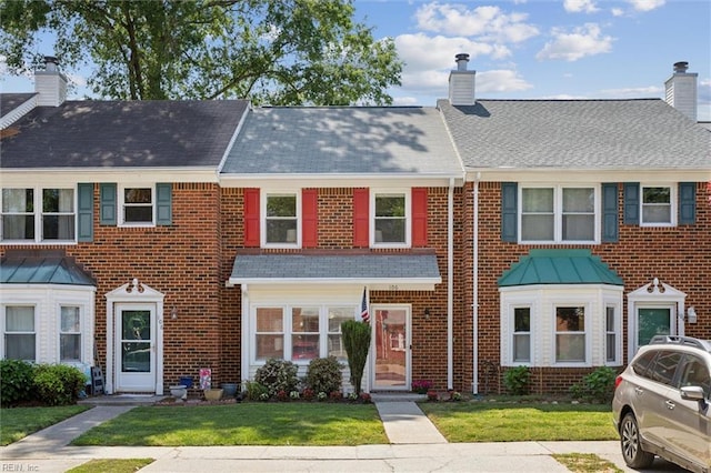 106 Kingsbridge Ln, Yorktown, VA 23692 - multi unit property with roof with shingles, a chimney, a front lawn, and brick siding