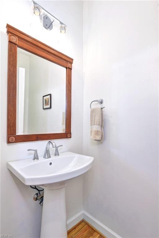 bathroom featuring baseboards and wood finished floors