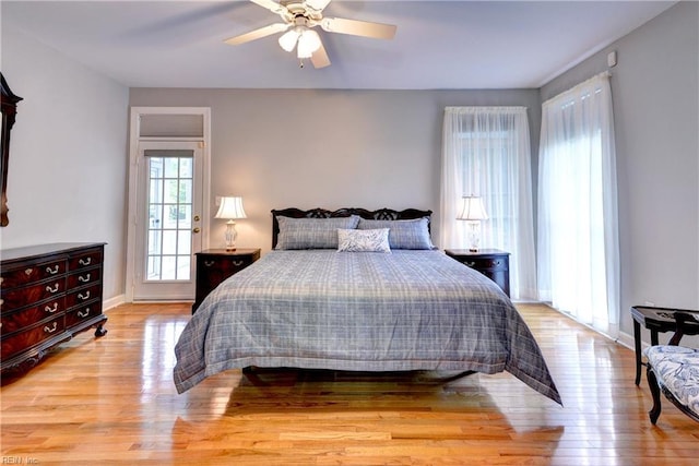 bedroom featuring baseboards, a ceiling fan, and wood finished floors