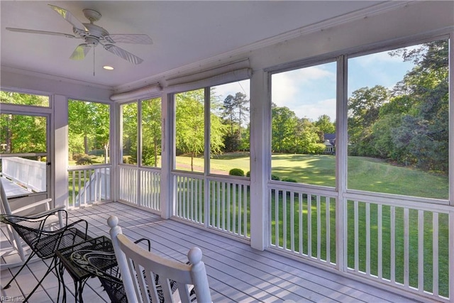 sunroom / solarium featuring ceiling fan