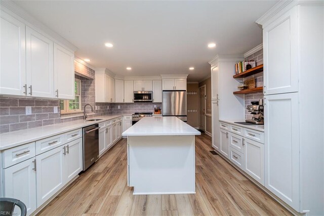 1130 Crystalwood Cir, Chesapeake, VA 23320 - kitchen featuring decorative backsplash, open shelves, a sink, light countertops, and stainless steel appliances