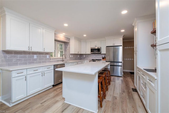 1130 Crystalwood Cir, Chesapeake, VA 23320 - kitchen with light countertops, white cabinets, tasteful backsplash, a sink, and stainless steel appliances