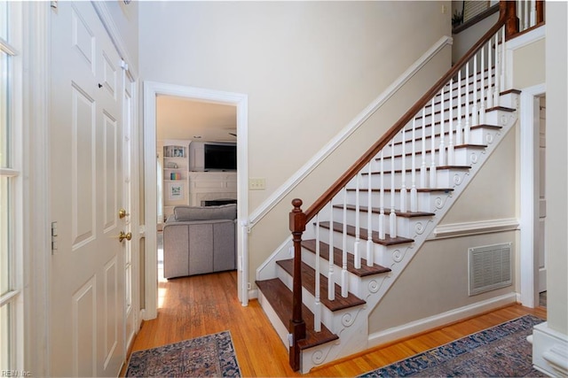 1130 Crystalwood Cir, Chesapeake, VA 23320 - stairway featuring baseboards, visible vents, wood finished floors, and a fireplace