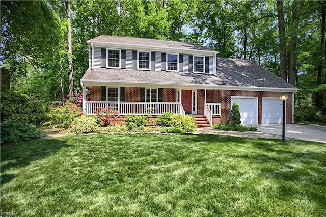 view of front of home featuring an attached garage, a front lawn, brick siding, covered porch, and driveway