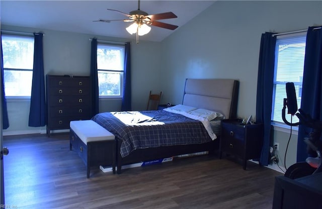 bedroom with baseboards, a ceiling fan, vaulted ceiling, and dark wood finished floors
