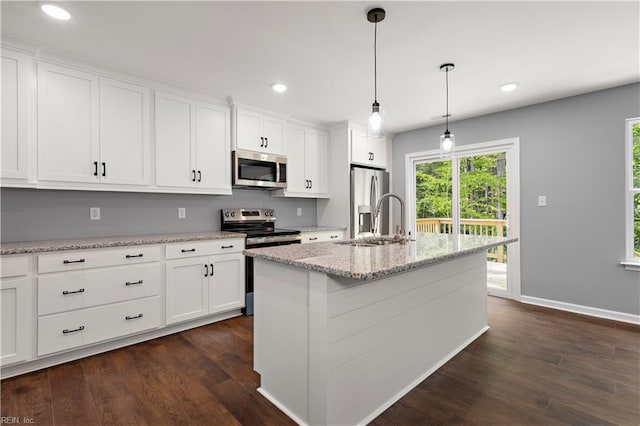 kitchen featuring a sink, appliances with stainless steel finishes, white cabinetry, and dark wood-type flooring