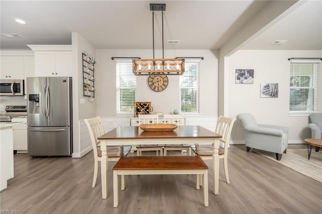 dining area with light wood-type flooring, recessed lighting, and visible vents