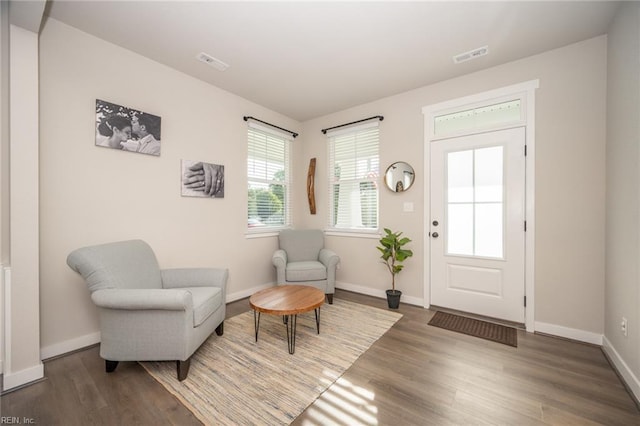 entryway with baseboards, wood finished floors, and visible vents