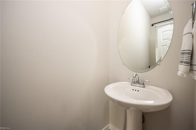 bathroom with baseboards and a sink