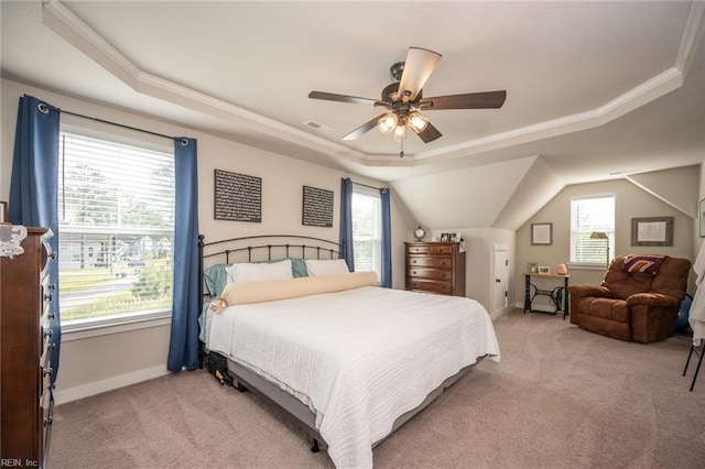 bedroom featuring a raised ceiling, visible vents, multiple windows, and light colored carpet