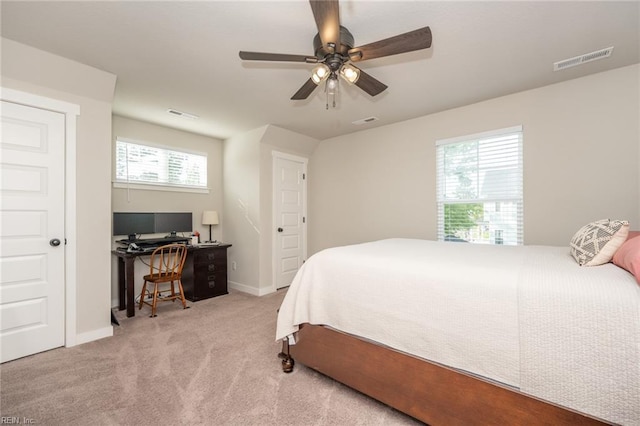 carpeted bedroom with baseboards, ceiling fan, and visible vents