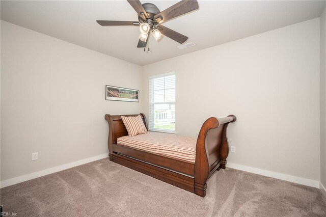 bedroom with carpet floors, baseboards, and visible vents