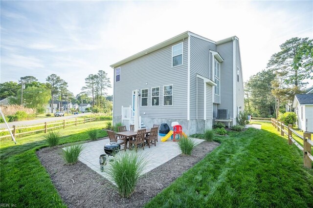 back of house with a patio area, fence, and a yard
