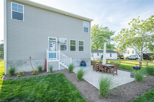 rear view of house featuring fence, a patio, and a yard