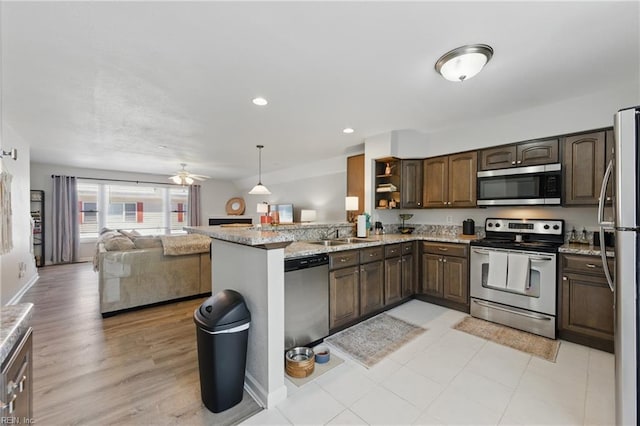 8550 Tidewater Dr Unit I2, Norfolk, VA 23503 - kitchen with light stone counters, open shelves, stainless steel appliances, and open floor plan