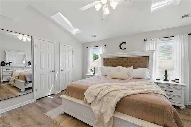 8550 Tidewater Dr Unit I2, Norfolk, VA 23503 - bedroom with ceiling fan, visible vents, light wood-style flooring, and lofted ceiling with skylight