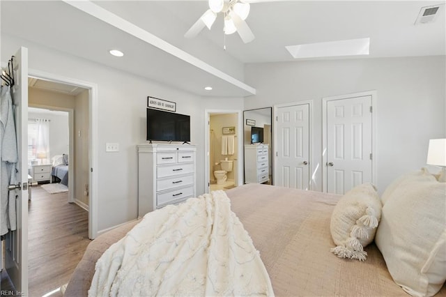 8550 Tidewater Dr Unit I2, Norfolk, VA 23503 - bedroom featuring multiple closets, recessed lighting, wood finished floors, visible vents, and lofted ceiling with skylight