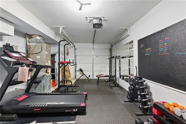 8550 Tidewater Dr Unit I2, Norfolk, VA 23503 - workout area featuring a textured ceiling and a garage