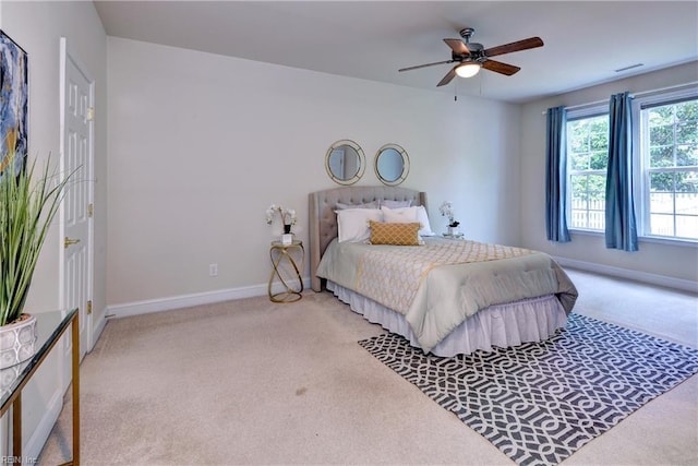 carpeted bedroom with baseboards, visible vents, and ceiling fan
