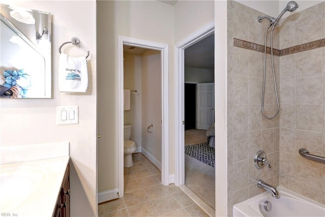 bathroom featuring tile patterned flooring, vanity, toilet, baseboards, and tub / shower combination