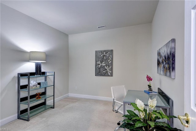 carpeted home office with visible vents and baseboards