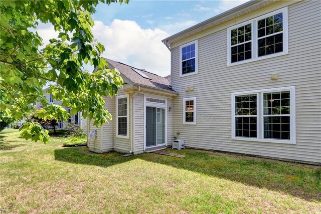 back of property featuring a lawn