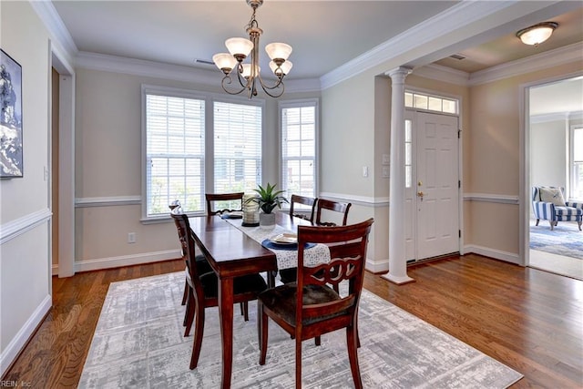 dining area featuring wood finished floors, a chandelier, and a healthy amount of sunlight