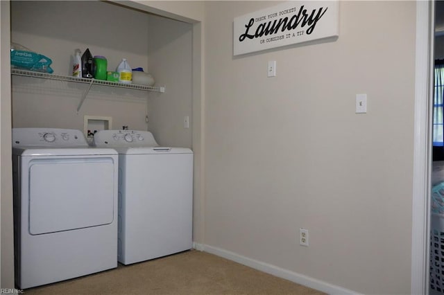 clothes washing area featuring washer and dryer, light colored carpet, and baseboards