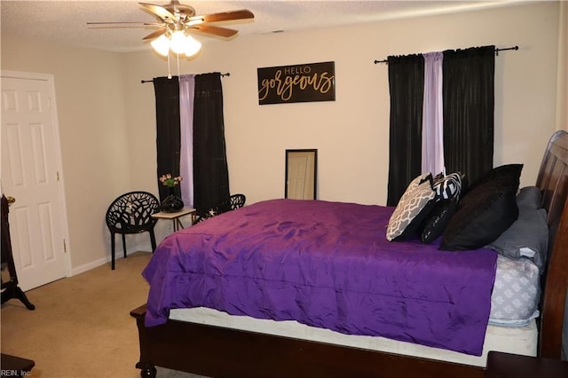 carpeted bedroom featuring a textured ceiling and ceiling fan