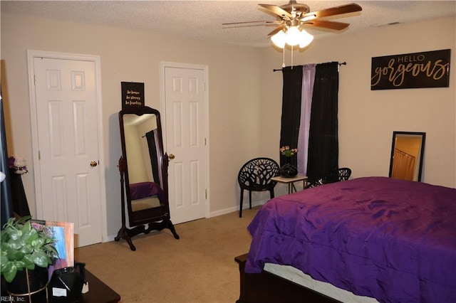 bedroom with carpet flooring, ceiling fan, and a textured ceiling