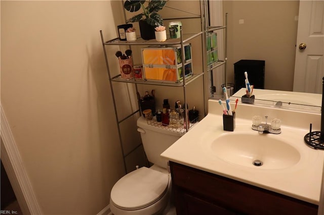 bathroom with toilet and vanity