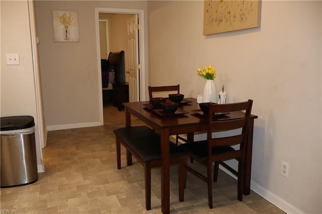 dining area featuring baseboards