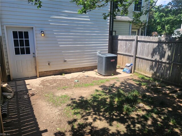 view of yard featuring cooling unit and fence
